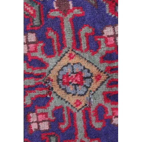 715 - A vintage blue ground Persian Tabriz carpet, with a traditional all over geometric design enclosed b... 