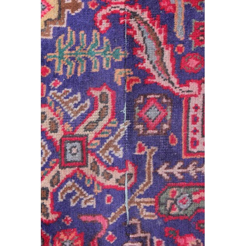 715 - A vintage blue ground Persian Tabriz carpet, with a traditional all over geometric design enclosed b... 