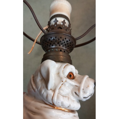 696 - A table lamp, late 19th century/early 20th century, the base modelled as a porcelain dog, with glass... 