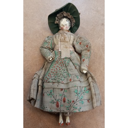 251 - A Victorian peddlers (pedlar) peg doll, mid to late 19th century, modelled as a lady in floral dress... 