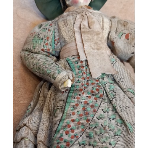 251 - A Victorian peddlers (pedlar) peg doll, mid to late 19th century, modelled as a lady in floral dress... 