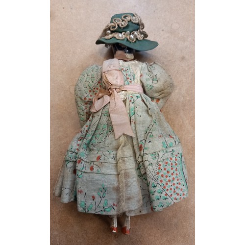 251 - A Victorian peddlers (pedlar) peg doll, mid to late 19th century, modelled as a lady in floral dress... 