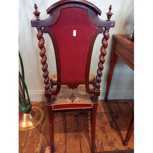 843 - A 19th century rosewood and upholstered elbow chair, the shield shaped padded back flanked by barley... 