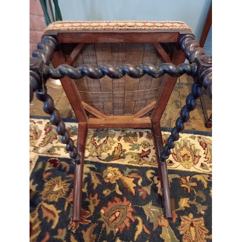 843 - A 19th century rosewood and upholstered elbow chair, the shield shaped padded back flanked by barley... 