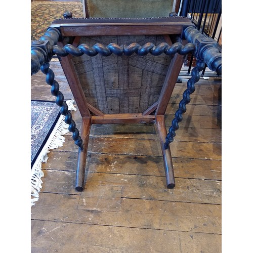 843 - A 19th century rosewood and upholstered elbow chair, the shield shaped padded back flanked by barley... 