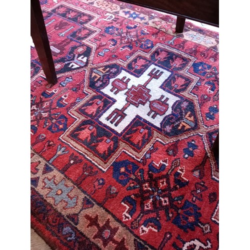 729 - A rich red ground Persian Heriz runner, bespoke medallion design, the three linked geometric medalli... 