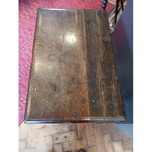 791 - A 17th century Welsh oak side table, the moulded plank top upon tapering cylindrical and block suppo... 