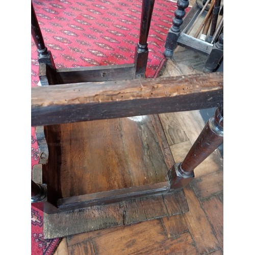 791 - A 17th century Welsh oak side table, the moulded plank top upon tapering cylindrical and block suppo... 