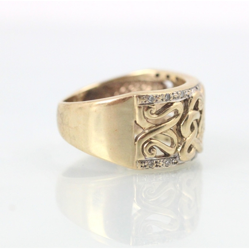 101 - A yellow metal dress ring, the openwork sinuous design to the centre of the ring leading to white st... 