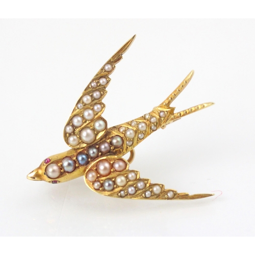 113 - An early 20th century yellow metal and seed pearl set dove brooch, the dove set with graduated seed ... 