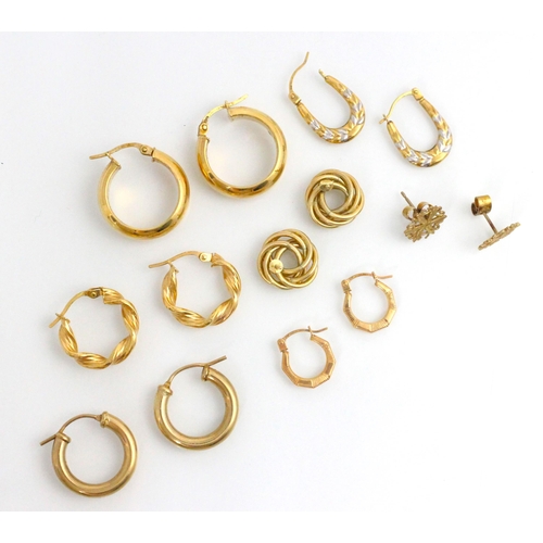 137 - A selection of yellow metal and gold coloured earrings, including a pair of plain polished hoop earr... 