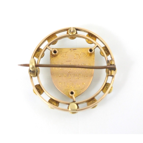 140 - A gold coloured brooch, the circular brooch with paste pearls and turquoise coloured stones, with ce... 