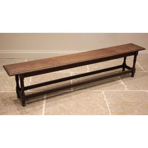 715 - An oak bench or form, late 19th/early 20th century, the rectangular moulded top upon baluster and bl... 