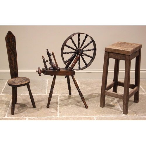 716 - A Welsh spinning wheel, probably fruit wood, 19th century, the twelve spindle wheel upon three turne... 