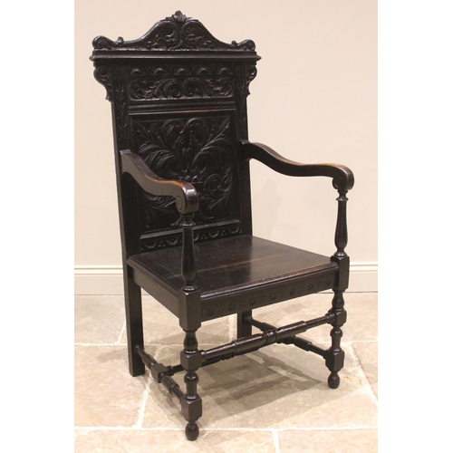 718 - A Victorian oak Wainscot chair, the profusely carved back panel with foliate, scroll and lunette det... 