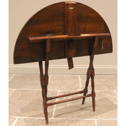 722 - A late 19th century stained beech wood coaching table by Thornton & Herne, the folding circular top ... 