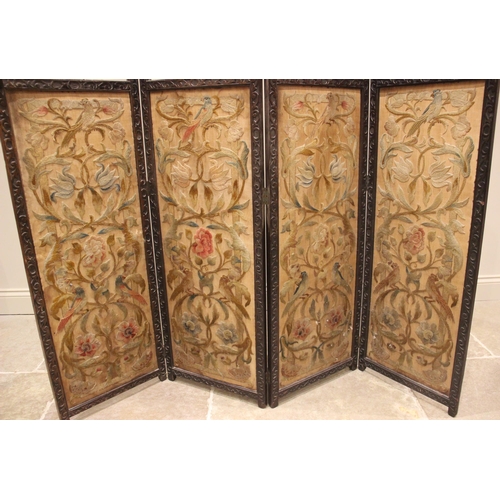 723 - A Victorian mahogany framed and crewelwork three fold dressing screen, each of the four sections wit... 