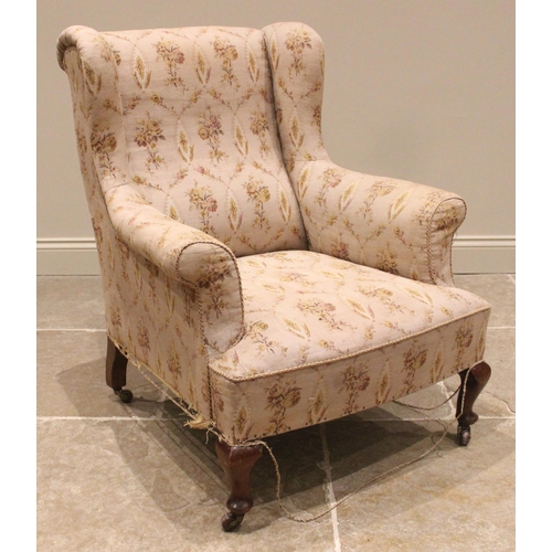 726 - A George III style wingback armchair, late 19th/early 20th century, the padded wing backs and scroll... 