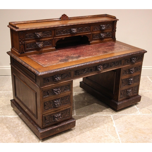 731 - A Victorian carved oak Green man desk, the superstructure back with a three quarter gallery and a cr... 