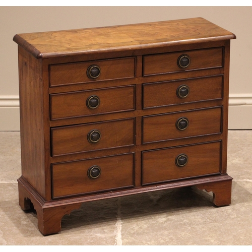 737 - An early 20th century and later constructed figured walnut collector's chest, the quarter veneered t... 