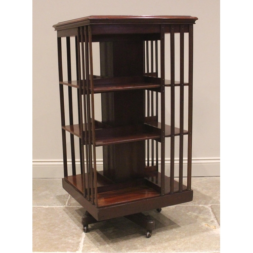 749 - An Edwardian mahogany revolving bookcase, the square top inlaid with a central satinwood batwing rou... 