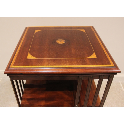 749 - An Edwardian mahogany revolving bookcase, the square top inlaid with a central satinwood batwing rou... 