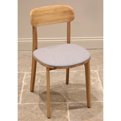 762 - An Artisan 'Tanka' ash dining chair, early 21st century, the curved back rest over an upholstered bo... 