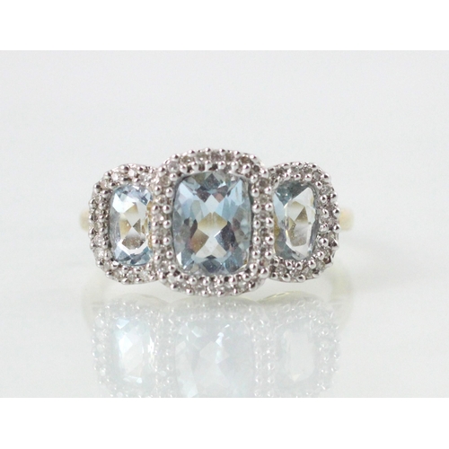 89 - An Edwardian style untested blue topaz triple cluster ring, the cushion cut untested topaz within a ... 