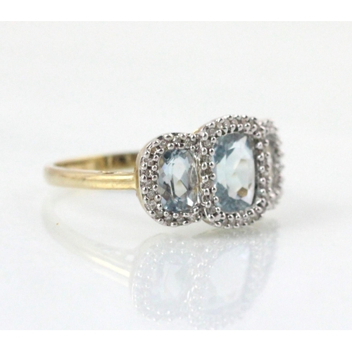 89 - An Edwardian style untested blue topaz triple cluster ring, the cushion cut untested topaz within a ... 