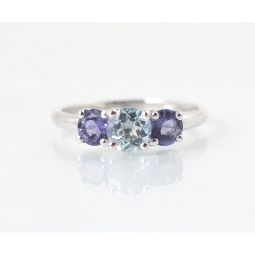 90 - A three stone untested amethyst and blue topaz ring, the central round cut untested blue topaz with ... 