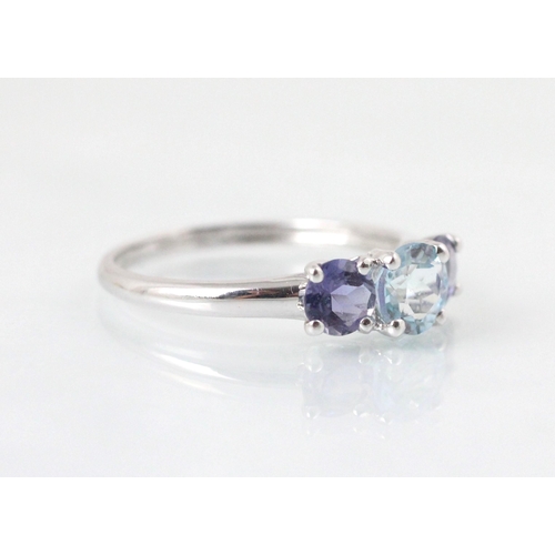 90 - A three stone untested amethyst and blue topaz ring, the central round cut untested blue topaz with ... 