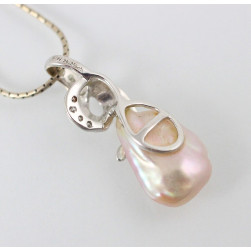 157 - An untested baroque pearl and diamond pendant, the stylised swirl pendant set with round cut diamond... 