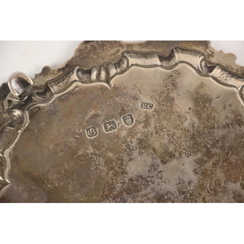 24 - A George III silver salver, Ebenezer Coker, London 1762, the shell cast rim above monogram and crest... 