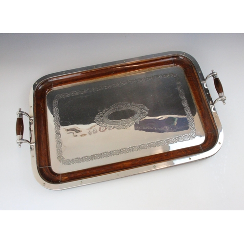 62 - A 20th century silver plated and oak tray, the twin barrel shaped handles above an ivy engraved bord... 