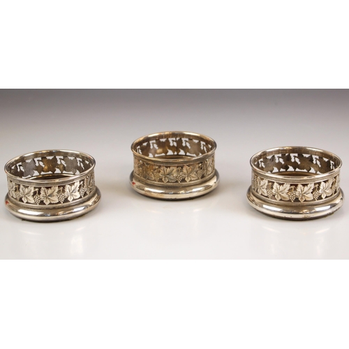 66 - A trio of silver plated coasters, the openwork galleries with ivy leaf detail and wooden inserts to ... 