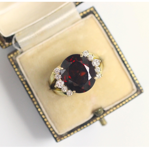 91 - A garnet and diamond dress ring, the oval cut garnet with five round cut diamonds to each side, with... 