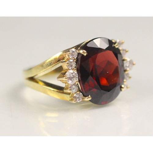 91 - A garnet and diamond dress ring, the oval cut garnet with five round cut diamonds to each side, with... 