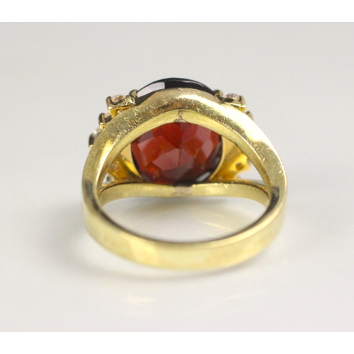 91 - A garnet and diamond dress ring, the oval cut garnet with five round cut diamonds to each side, with... 