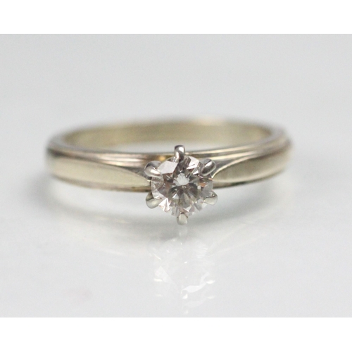 97 - A certified diamond solitaire ring, the central round cut diamond claw set in raised mount, upon pla... 