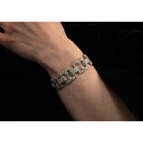 135 - An early 20th century diamond set bracelet, circa 1920, the seven openwork square panels pave set wi... 