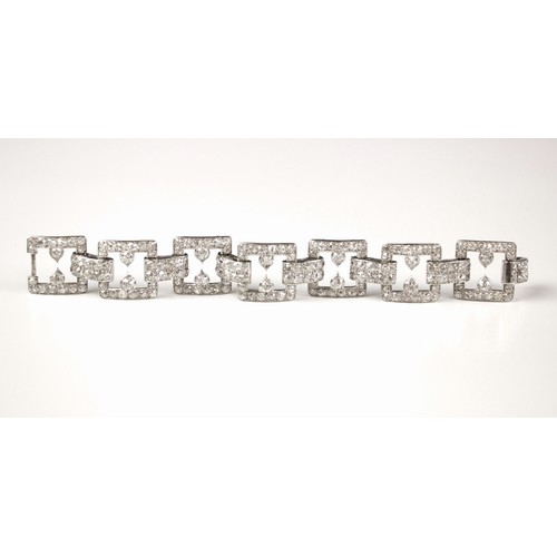 135 - An early 20th century diamond set bracelet, circa 1920, the seven openwork square panels pave set wi... 