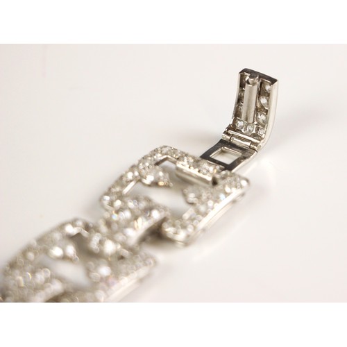 135 - An early 20th century diamond set bracelet, circa 1920, the seven openwork square panels pave set wi... 