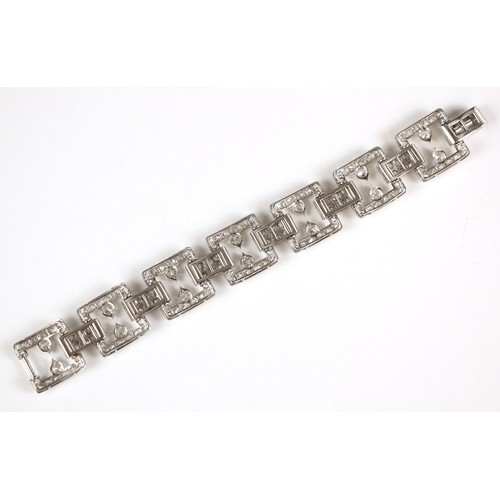 135 - An early 20th century diamond set bracelet, circa 1920, the seven openwork square panels pave set wi... 