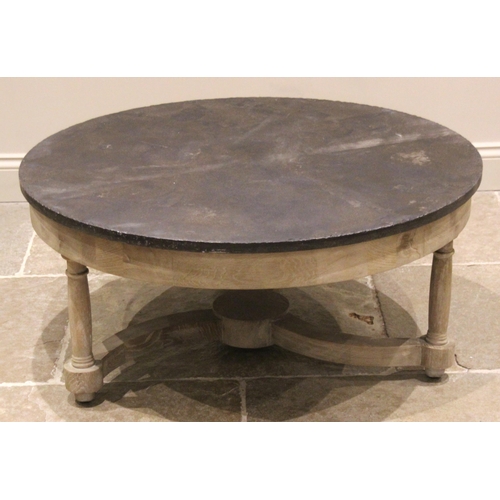 767 - An Oka 'Flavian' slate top oak coffee table, the circular slate top upon three turned supports, unit... 