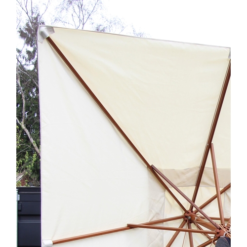 779 - A large garden/patio parasol, by Skagerak, Denmark, folding white fabric cover upon a hardwood pole ... 