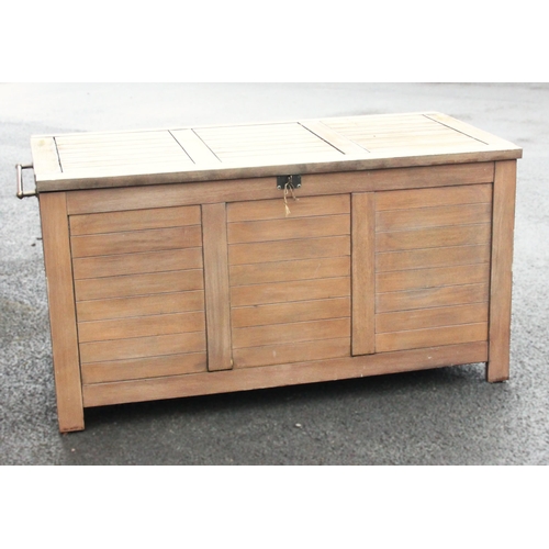 781 - An outdoor teak storage chest, of slatted form with a hinged cover and fitted side handles, upon sti... 