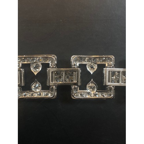 135 - An early 20th century diamond set bracelet, circa 1920, the seven openwork square panels pave set wi... 