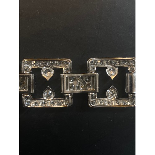 135 - An early 20th century diamond set bracelet, circa 1920, the seven openwork square panels pave set wi... 