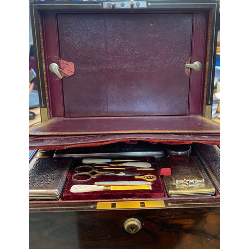 18 - An early 19th century brass bound coromandel vanity case, circa 1840, the hinged cover with decorate... 