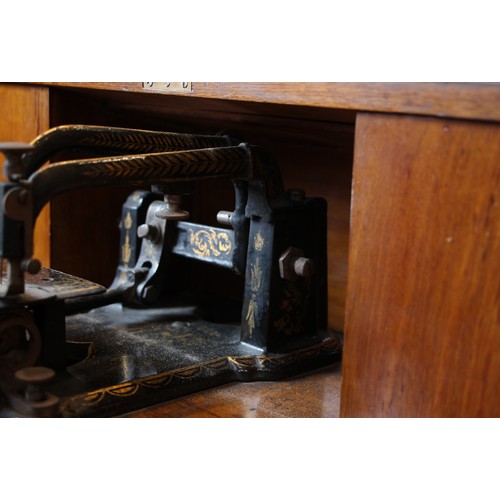 717 - A Victorian figured walnut davenport with integral Japanned 'The Roxburgh' sewing machine by Redpath... 